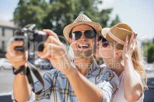 Hip young couple taking a selfie with camera