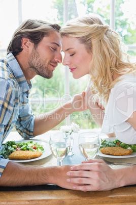 Cute affectionate couple having a meal together