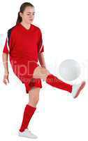 Cute football player kicking ball