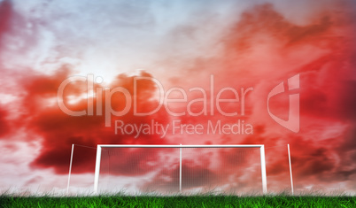 Football goal under red cloudy sky