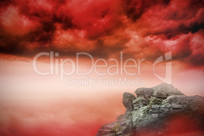 Large rock overlooking red sky