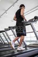 Fit man jogging on the treadmill