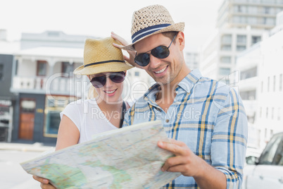 Young tourist couple consulting the map