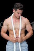 Strong crossfitter posing with rope around neck