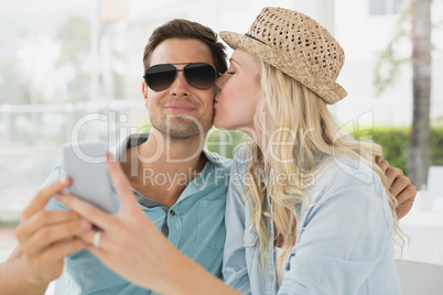 Hip young couple taking a selfie together