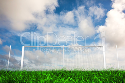 Football goal under blue cloudy sky