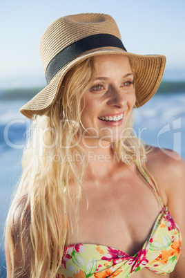 Gorgeous blonde in straw hat smiling on beach
