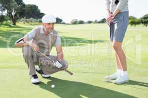 Golfing couple on the putting green