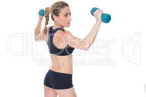 Female bodybuilder holding two dumbbells with arms up