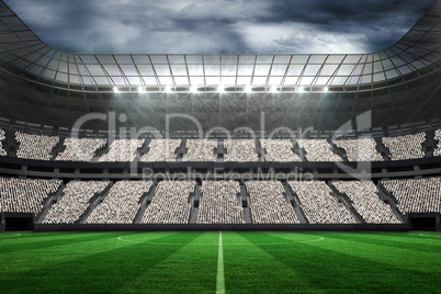 Large football stadium with fans in white