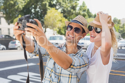 Young hip couple taking a selfie