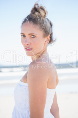 Pretty blonde on the beach looking at camera