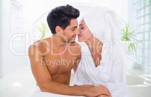 Attractive couple kissing in towels