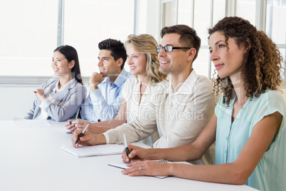 Casual business team listening during meeting Casual business team listening during meeting