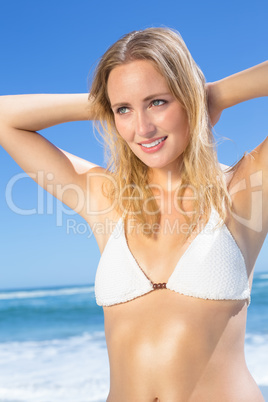 Beautiful blonde in white bikini on the beach