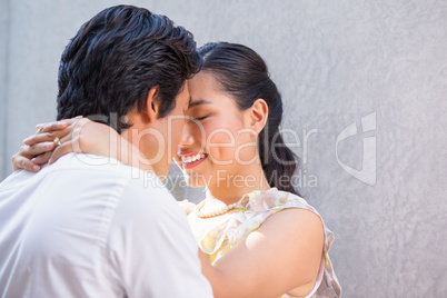 Asian couple embracing and smiling