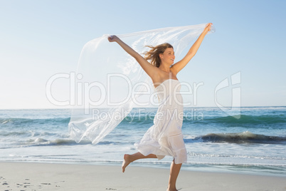 Beautiful smiling blonde in white sundress on the beach with sca
