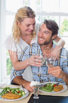 Cute smiling couple enjoying a meal together