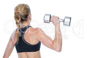 Female bodybuilder holding a large dumbbell rear view