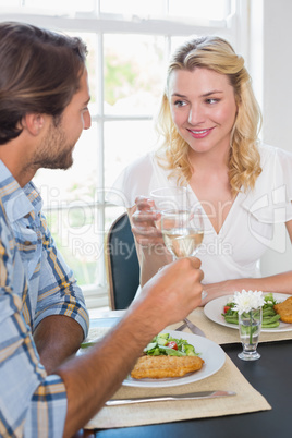 Cute smiling couple having a meal together