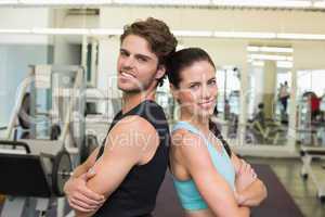 Fit attractive couple smiling at camera