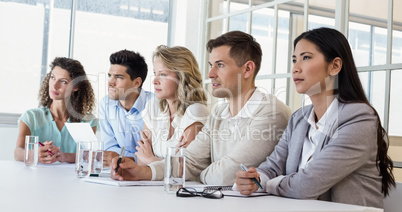 Casual business team listening during meeting