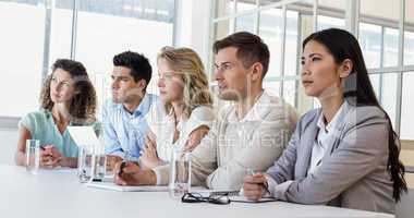 Casual business team listening during meeting