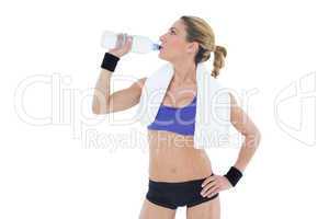 Strong blonde drinking from water bottle