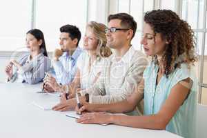 Casual business team listening during meeting