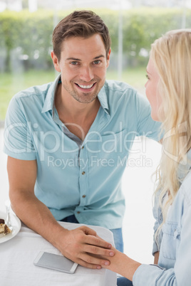 Hip young couple sitting at table