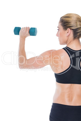 Female bodybuilder holding a blue dumbbell