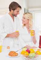 Couple having breakfast in their bathrobes