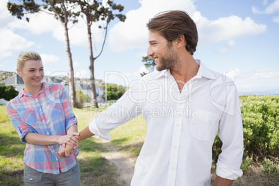Smiling couple standing outside together in their garden