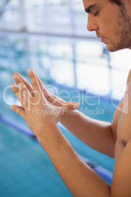 Fit swimmer sitting by the pool