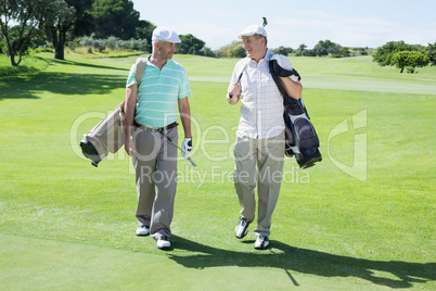 Golfer friends walking and chatting