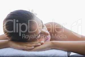 Calm brunette lying on a towel poolside