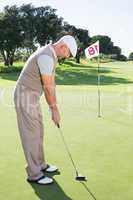 Golfer on the putting green at the eighteenth hole