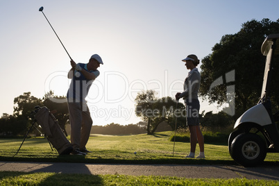 Golfing couple teeing off for the day