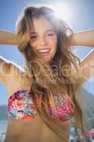Beautiful smiling blonde in floral bikini on the beach