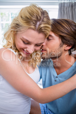 Cute affectionate couple relaxing on bed together