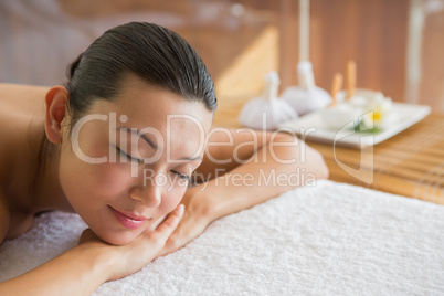 Content brunette relaxing on massage table