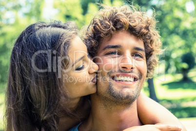 Cute couple relaxing on park bench