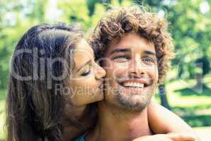 Cute couple relaxing on park bench