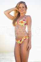 Gorgeous blonde in floral bikini smiling at camera