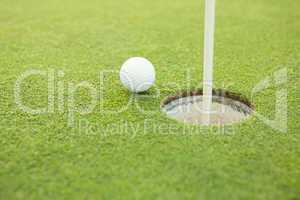 Golf ball at the edge of the hole