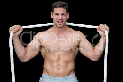 Tough crossfitter posing with rope around neck