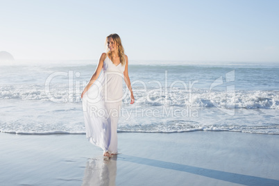 Pretty blonde at the beach in white sundress