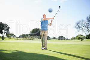 Concentrating golfer taking a shot