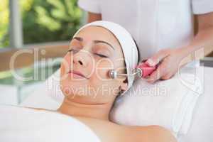 Peaceful brunette getting micro dermabrasion