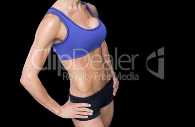 Strong woman posing in sports bra and shorts